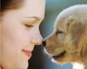 Woman Rubbing Noses with Puppy ca. 2002